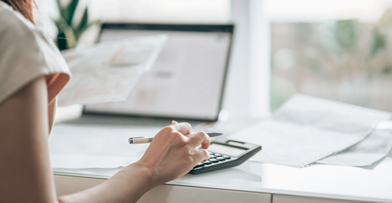 Woman seated at a desk working on her taxes