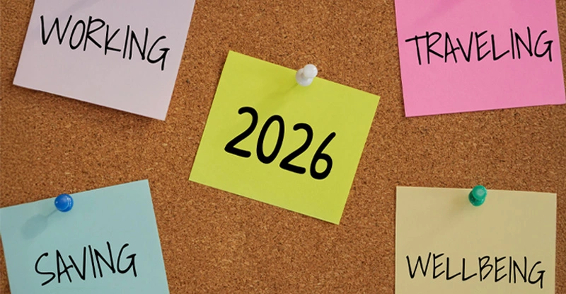 5 post-it paper pin on board with number 2026 in the middle and word working, saving, traveling, wellbeing around new year goal.