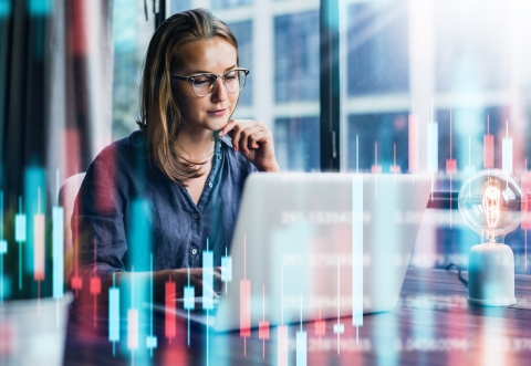 lady looking pensively at a laptop screen on a virtual colorful background
