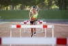 Athlete jumping over hurdles